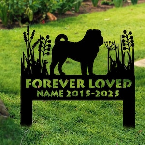 May include: A black metal garden stake featuring a silhouette of a pug dog. The stake reads "FOREVER LOVED" above a line for a name and dates 2015-2025. The stake is placed in a grassy area with colorful flowers in the background.