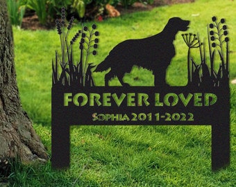May include: Black metal garden memorial with a silhouette of a dog and the words "Forever Loved" and "Sophia 2011-2022".
