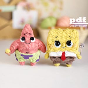 May include: Two crocheted figures of cartoon characters. One is pink with a starfish shape, wearing green shorts with purple trim. The other is yellow, square-shaped, with a white shirt, red tie, and brown trousers. The figures have black eyes and are smiling.