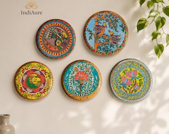 May include: Five circular wall plates featuring vibrant hand-painted designs. The plates display colorful motifs including stylized birds, floral patterns, and intricate geometric borders in shades of orange, blue, green, yellow, and pink.