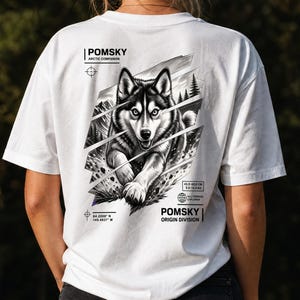 May include: A white t-shirt featuring a black and white graphic of a Pomsky dog on the back. The design includes text reading POMSKY ARCTIC COMPANION, POMSKY ORIGIN DIVISION, and coordinates, along with a box showing 45.0-60.0 CM and 9.0-14.0 KG.