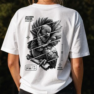 May include: A white t-shirt featuring a black and white graphic of a Jacobin pigeon on the back. The design includes diagonal lines, the text Jacobin Pigeon, Elegant Ruff, Species ID JP-001, and a measurement indicator labeled 320 mm.