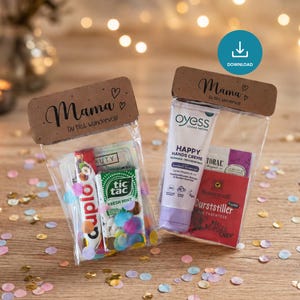 May include: Two gift bags with the text "Mama" and "Du bist wundervoll!" printed on them. One bag contains Tic Tac mints, a Cuplo candy, and confetti. The other bag has hand cream and tea.