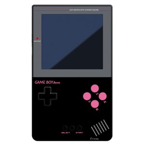 May include: A black and pink Game Boy Zero handheld gaming console with a dot matrix screen and the text "GAME BOYZero" on the front. The console has a directional pad, four buttons, and a start and select button.