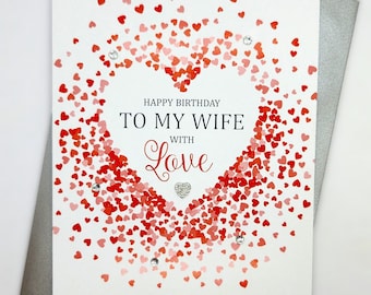 May include: A white card with a red heart made of small red hearts. The card says "Happy Birthday To My Wife With Love".