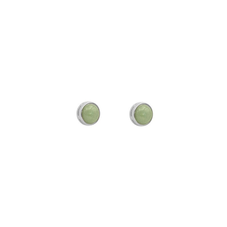 May include: A pair of silver stud earrings with a light green stone in the center of each earring.
