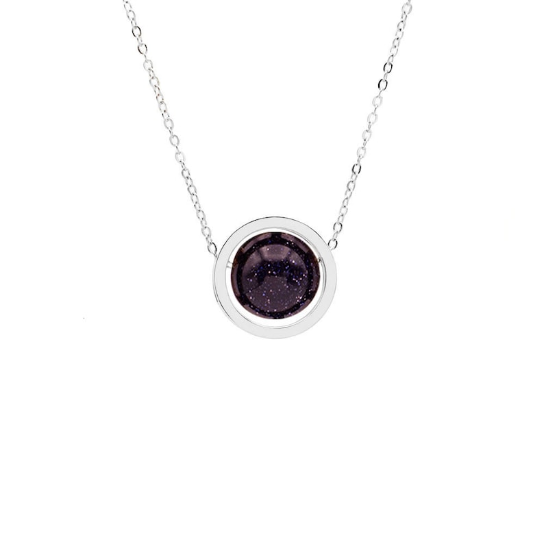 May include: A silver chain necklace with a round pendant featuring a dark purple stone surrounded by a silver ring.