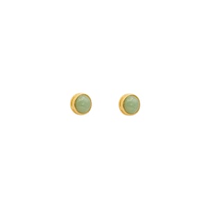 May include: A pair of gold stud earrings with light green round gemstones.