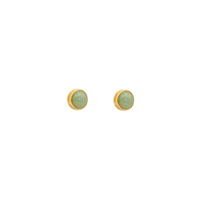May include: A pair of gold stud earrings with light green round gemstones.