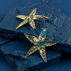 Bold brass starfish earrings with natural blue patina and sterling silver ear studs. Patina is waterproof and stable, it is not covered with wax or varnish. Earrings are a bit mismatched due to their hand made nature.