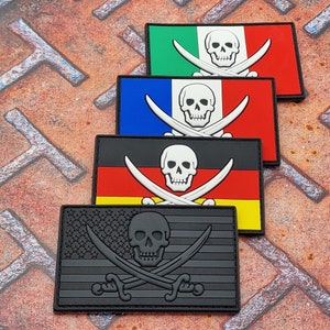 May include: Four embroidered patches featuring a skull and crossbones design on different national flags. The flags are Italian, French, German, and American. The patches are black with white stitching.