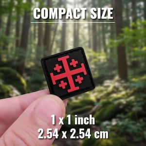 May include: A black square patch with a red Jerusalem cross design. The patch is 1 x 1 inch in size, with the text "COMPACT SIZE" above and "1 x 1 inch 2.54 x 2.54 cm" below. The background is a blurred forest scene.