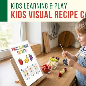 May include: A child prepares fruit skewers using a visual recipe card. The card, titled "Fruit Rainbow Skewers," displays illustrations of strawberries, bananas, and grapes. The scene is set in a kitchen with various fruits and a wooden cutting board.