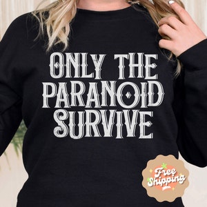 May include: Black sweatshirt with white text that reads "Only the Paranoid Survive".