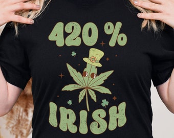 May include: Black t-shirt featuring a green marijuana leaf design and the text "420% Irish" in a retro font.