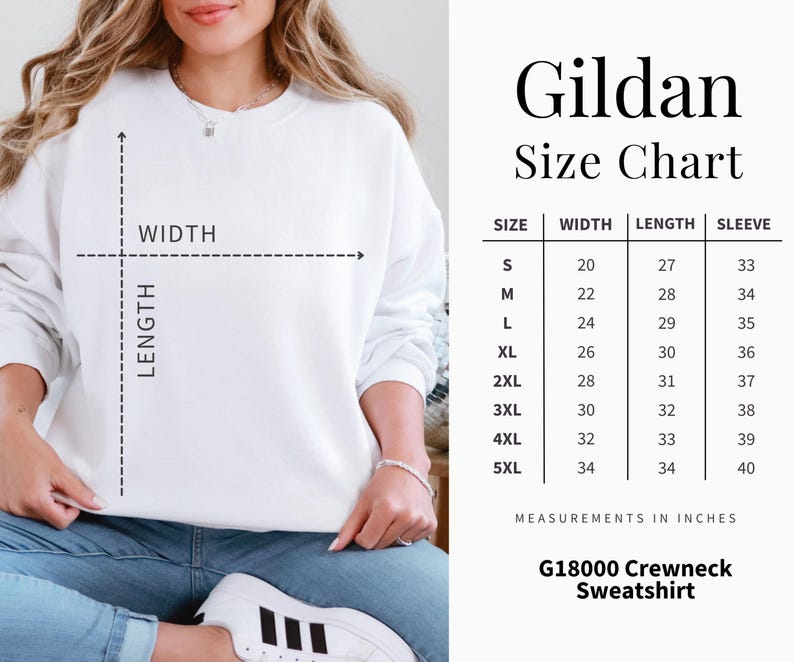 Puede incluir: Una sudadera Gildan blanca con cuello redondo y una tabla de tallas. La tabla muestra medidas en pulgadas para ancho, largo y largo de manga, desde la talla peque&ntilde;a hasta la 5XL. La sudadera es G18000.