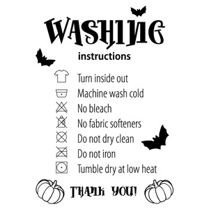 May include: A white graphic with black text and illustrations. The text reads "WASHING instructions" and provides care symbols and instructions. Includes bat and pumpkin illustrations. The text "THANK YOU!" is also present.