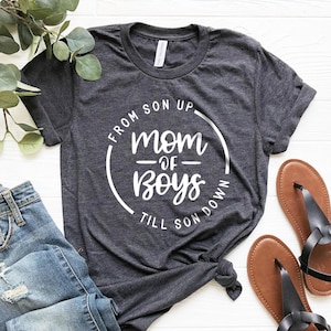 May include: A dark gray t-shirt with a white circle graphic that says "From Son Up - Mom of Boys - Till Son Down".