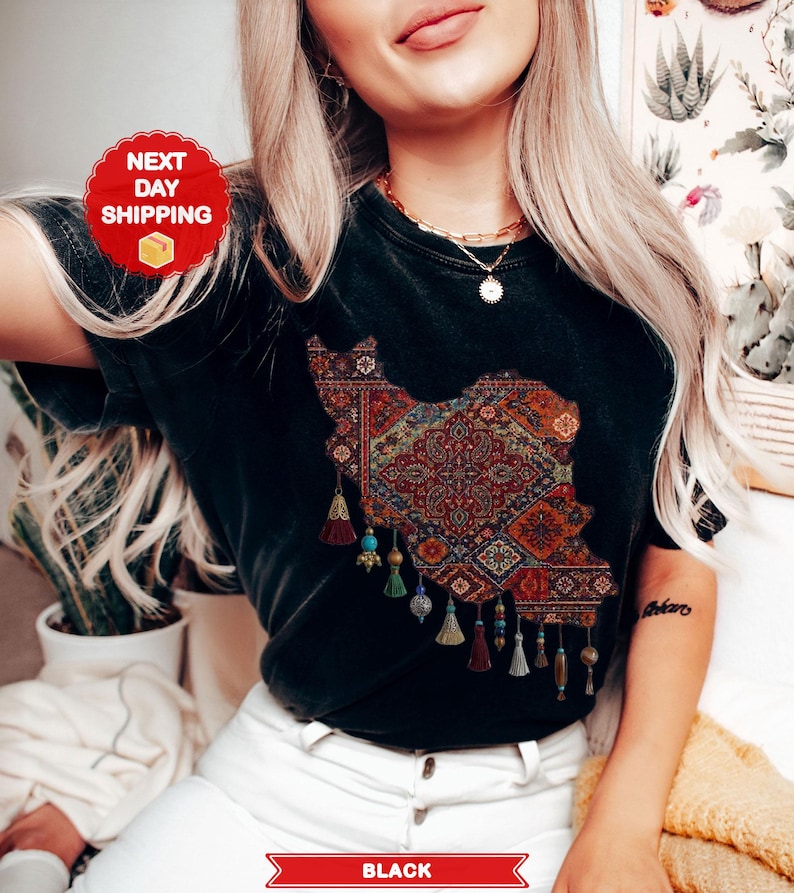 May include: Black t-shirt featuring a detailed map of Iran, filled with a colorful rug design. The shirt has decorative tassels and the word "BLACK" at the bottom. A red circle with "NEXT DAY SHIPPING" is visible.
