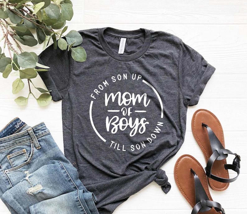 May include: A dark gray t-shirt with a white circle graphic that says "From Son Up - Mom of Boys - Till Son Down".