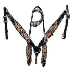 May include: Black and gold Western horse tack set. The set features intricate floral tooling, silver-tone hardware, and decorative studs. The set includes a headstall, breast collar, and reins, all crafted from leather.