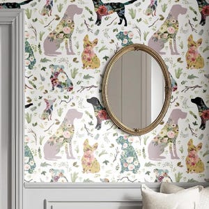 May include: Wallpaper featuring a repeating pattern of dogs in various colors, each adorned with floral designs. The background is white with green foliage and branches. An oval gold mirror hangs on the wall.