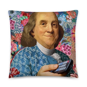 May include: A colorful throw pillow featuring a portrait of Benjamin Franklin holding a remote control. The background is a patchwork of floral and geometric patterns in shades of pink, blue, green, and red.