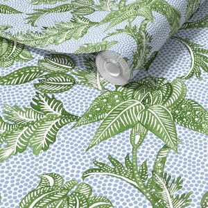 May include: A roll of wallpaper featuring a repeating pattern of green and white botanical illustrations on a light blue background with small white dots. The design includes various leaf shapes and plant details.