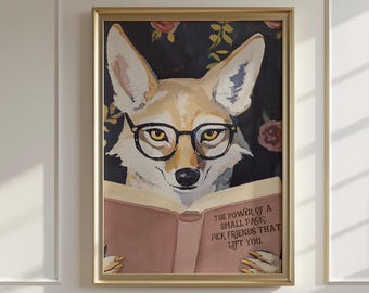 May include: Framed artwork featuring a coyote wearing glasses and reading a book. The book's cover is pink with the text: "THE POWER OF A SMALL PACK. PICK FRIENDS THAT LIFT YOU." The background is dark with floral accents.