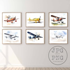 May include: Six watercolour paintings of different aeroplanes, each framed in a light wood frame. The aeroplanes are painted in various colours, including red, yellow, blue, and white. The paintings are displayed on a white wall.