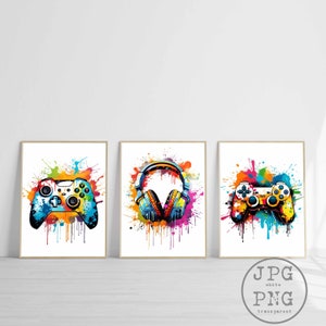 May include: Three colorful digital art prints featuring a video game controller, headphones, and a second video game controller. Each image has a white background with colorful paint splatters.