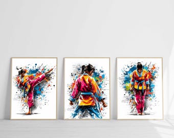 May include: Set of three framed art prints featuring watercolor-style illustrations of a person in a karate uniform. The artwork showcases dynamic poses with vibrant splashes of color, including pink, blue, yellow, and orange.