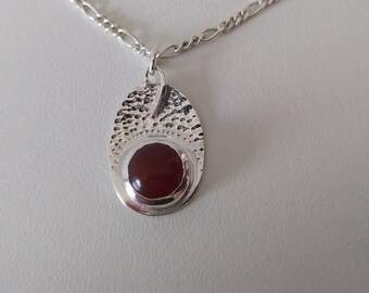 A hammered oval pendant, made with sterling silver and round natural stones (carnelian, aventurine or sodalite), with silver chain or cord.