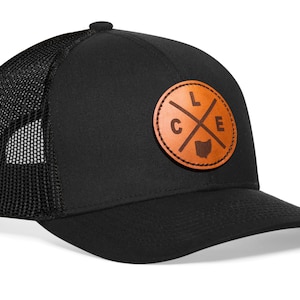 May include: Black trucker hat with a brown leather patch featuring the letters "LCE" in a circle with a cross and the outline of the state of Ohio.