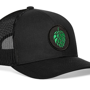 May include: Black trucker hat with a green and black embroidered hop cone patch.