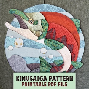 May include: A circular fabric art piece depicting a fish in shades of red, green, and blue, featuring textured patterns and layered segments. Below the image, text reads: KINUSAIGA PATTERN PRINTABLE PDF FILE.