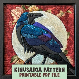 May include: A framed fabric art piece featuring a raven against a large white moon. The raven is composed of various blue, purple, and black patterned fabric scraps. The background is a red floral fabric. Text reads: KINUSAIGA PATTERN PRINTABLE PDF FILE.