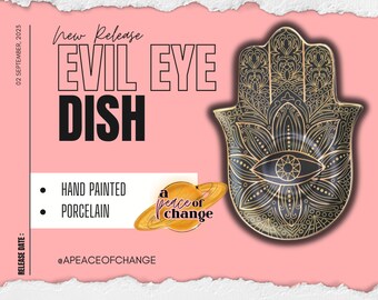 May include: A black and gold hand-painted porcelain dish shaped like a hamsa, a protective symbol with an evil eye in the center. The dish is decorated with intricate floral patterns.