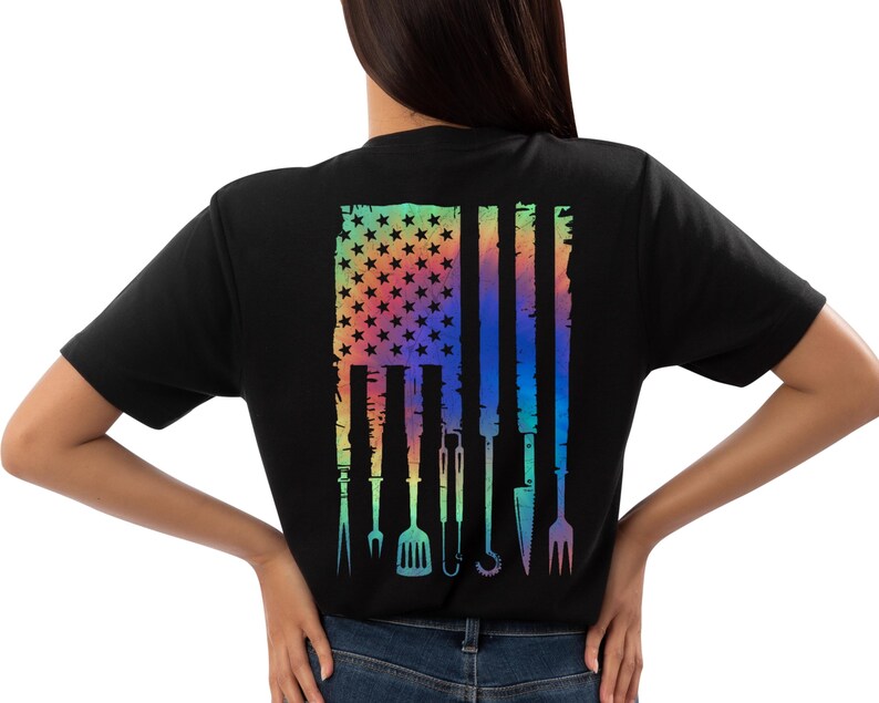 T-shirt featuring a rainbow American flag design made of BBQ grilling tools like tongs, spatula, and fork