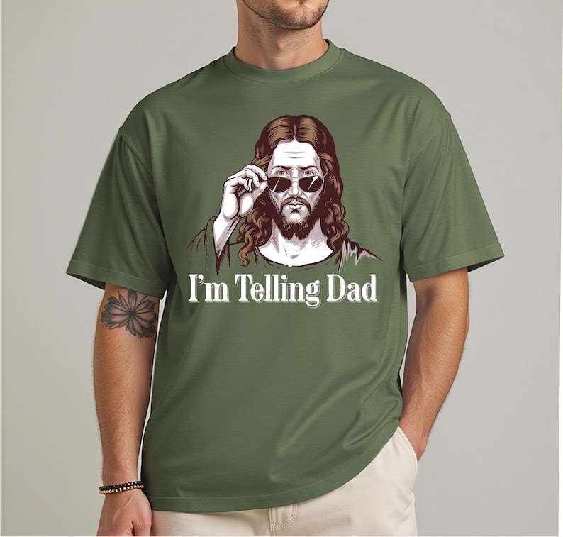 May include: A green t-shirt with a cartoon image of Jesus wearing sunglasses and the text "I'm Telling Dad".