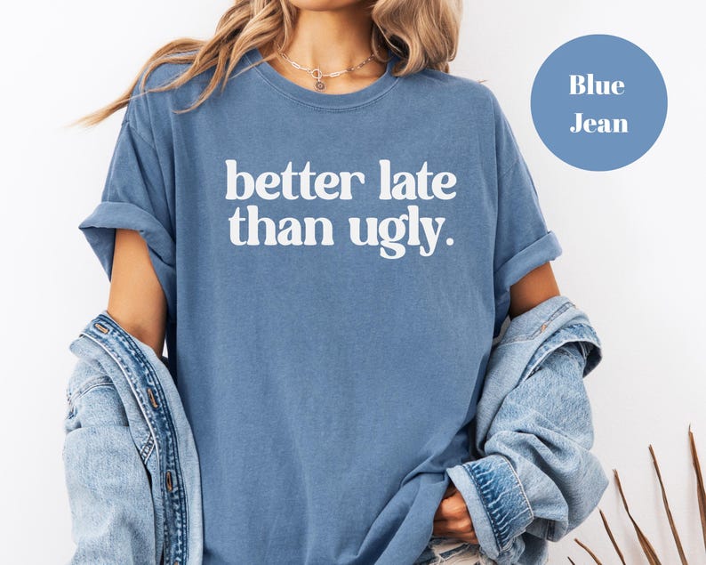 T-shirt with bold orange text that reads better late than ugly in playful retro-style font