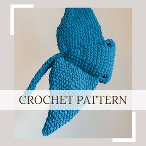 May include: A crochet pattern for a blue stingray. The stingray is crocheted in a textured stitch and has a long tail.