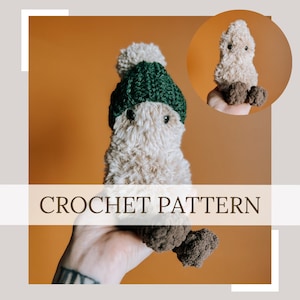 May include: Crochet pattern for a small, fluffy, brown creature wearing a green and white crocheted hat. The creature is being held in a hand with a tattoo.