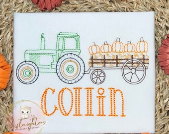 May include: White fabric with an embroidered design featuring a green tractor pulling a wagon filled with pumpkins and hay bales. The name "COLLIN" is embroidered in orange. A logo for "Owlknighters Children's Boutique" is in the lower left corner.