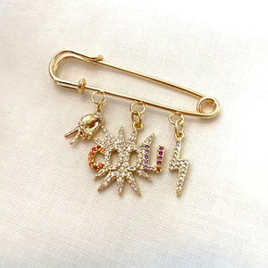 Gold plated pin with 3 pendant. Cool and peace. Statement pin for denim jackets or jeans.