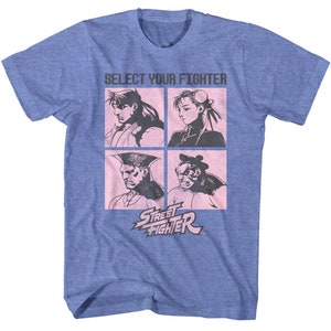 May include: A blue t-shirt with a pink graphic of four characters from the Street Fighter video game. The graphic says "Select Your Fighter" and "Street Fighter".