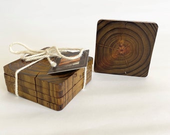 Può includere: Set di sei sottobicchieri in legno con finitura in legno naturale. I sottobicchieri sono quadrati e presentano un'unica venatura. I sottobicchieri sono legati insieme con uno spago.