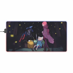 May include: A colorful mousepad featuring characters from the animated series Adventure Time. The characters are Finn, Jake, Marceline, and Princess Bubblegum. The background is a dark forest with fireflies.