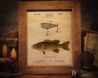 Pode incluir: Uma impressão vintage emoldurada com uma ilustração de um achigã-de-boca-pequena e uma patente de isca de pesca. A impressão inclui o texto "QUAIL RIDGE CREATIONS" e "FRAME NOT INCLUDED". A moldura é de madeira.