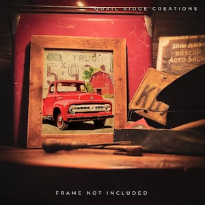 May include: A framed print featuring a vintage red truck, a red barn, and the text "53 TRUCK". The print is set against a rustic background with tools and vintage license plates. The text "FRAME NOT INCLUDED" is at the bottom.